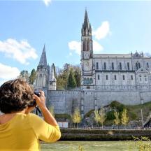 a woman taking a picture of a castle
