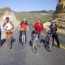 a group of people riding bikes on a road