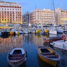 a group of boats docked in a harbor with buildings