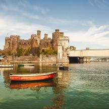 a boat in the water in front of a castle