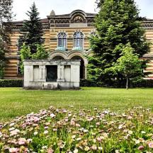 a building with a field of flowers in front of it