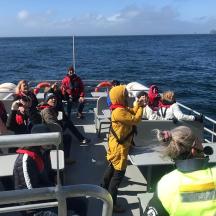 a group of people on a boat in the ocean