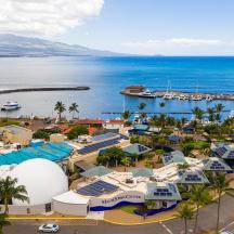 an aerial view of a resort next to the ocean