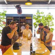a group of people standing around a table with wine glasses