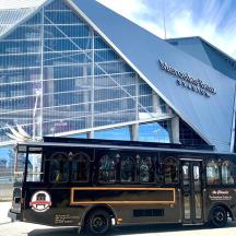 a black bus parked in front of a building