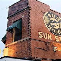 a brick building with a sun studio sign on it