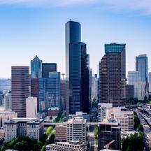 a city skyline with tall buildings and a freeway