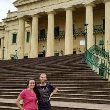 a man and a woman standing in front of a building