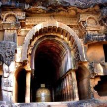 a stone building with a tunnel with a vase in it