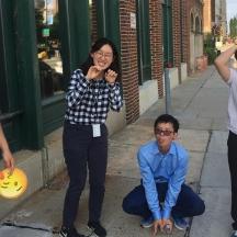 a group of people standing on a sidewalk