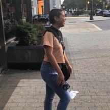 a man walking down a street holding a camera