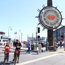 a group of people riding bikes down a city street