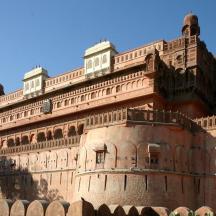 a large brick building with a blue sky in the background