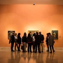 a group of people standing in a museum looking at art