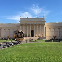 a large building with a sculpture in front of it
