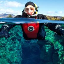 a person in a wetsuit is underwater with a surfboard