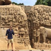 a man standing in front of a statue of an elephant