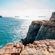 a view of the ocean from a rocky cliff