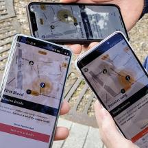 three people holding two cell phones in their hands