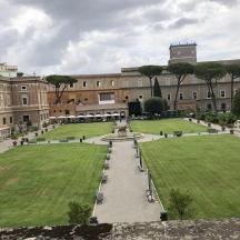 a large building with a park in front of it