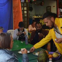 a group of people sitting around a table eating food