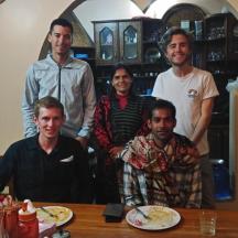 a group of men posing for a picture at a table