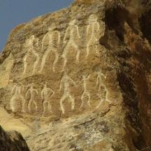 a rock wall with writing on it