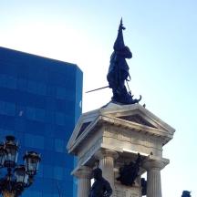 a statue on top of a building with a street light