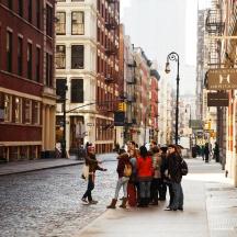 a group of people standing on a city street
