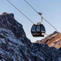 a ski lift in front of a mountain