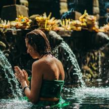 a woman standing in the water in a fountain