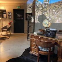 a room with a desk and a room with chairs