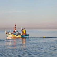 two people on a boat in the water