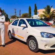 a man wearing a mask standing next to a white car