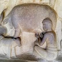 a stone relief of an elephant and a child