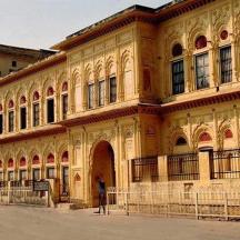 a large building with a man standing in front of it