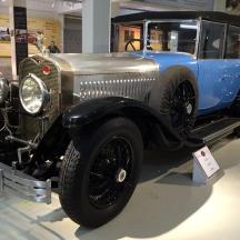 an old car is on display in a museum