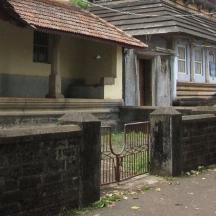 an old house with a fence in front of it