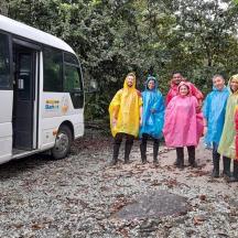 a group of people standing in front of a bus