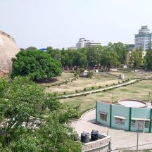 a view of a park with a large building