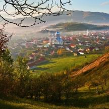 a small town on a hill in the fog