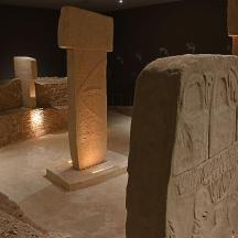 a group of stone pillars in a room at night