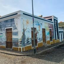 a building with a mural on it on a street