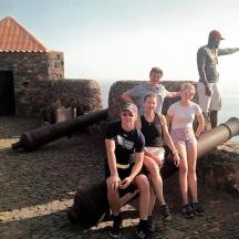 a group of people sitting on top of a cannon