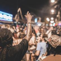 a crowd of people on a street at a concert