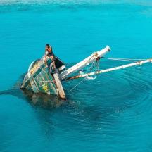 a person standing on a boat in the water