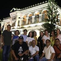 a group of people posing in front of a building