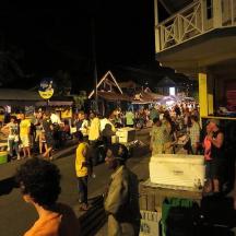 a crowd of people standing in a street at night