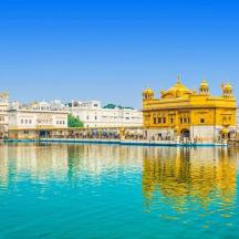 a view of the golden temple with its reflection in the water