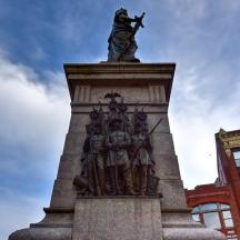 a statue of a man standing on top of a monument